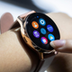 A person wearing a Samsung Galaxy Active 2 Watch presses on the screen.